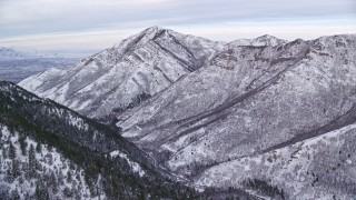 5.5K aerial stock footage approach Grandeur Peak in the wintery Wasatch Range at sunrise, Utah Aerial Stock Footage | AX124_164E