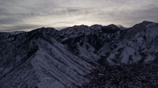 5.5K aerial stock footage of Wasatch Range snow mountains bordering suburbs at sunrise in Utah Aerial Stock Footage | AX124_181