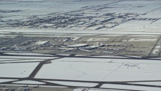 5.5K aerial stock footage of Salt Lake City International Airport with winter snow, Utah Aerial Stock Footage | AX125_008