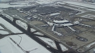 5.5K aerial stock footage of terminals at SLC Airport with winter snow in Utah Aerial Stock Footage | AX125_013E