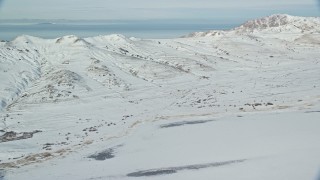 5.5K aerial stock footage of panning across wintery mountains on Antelope Island with snow in Utah Aerial Stock Footage | AX125_030E