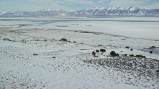 5.5K aerial stock footage orbit sheets of ice on the Great Salt Lake seen from Antelope Island, Utah Aerial Stock Footage | AX125_085