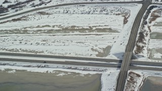 5.5K aerial stock footage of tracking an SUV on Interstate 80 through winter countryside in Magna, Utah Aerial Stock Footage | AX125_108