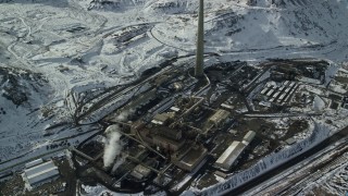 5.5K aerial stock footage orbit factory and smoke stack in winter near Magna, Utah Aerial Stock Footage | AX125_112E