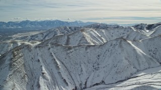 5.5K aerial stock footage pan across a snowy ridge of the Oquirrh Mountains, Utah Aerial Stock Footage | AX125_118E