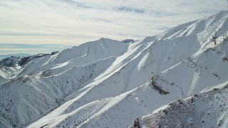 5.5K aerial stock footage of winter snow on the Oquirrh Mountains of Utah Aerial Stock Footage | AX125_120E