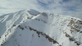 5.5K aerial stock footage approach the summit of Kessler Peak in the Oquirrh Mountains in winter, Utah Aerial Stock Footage | AX125_123E