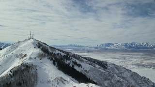 5.5K aerial stock footage of radio towers on Farnsworth Peak and snow valley in distance, Utah Aerial Stock Footage | AX125_132