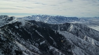 5.5K aerial stock footage approach Oquirrh Mountains with snow and trees on slopes, Utah Aerial Stock Footage | AX125_139