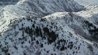 5.5K aerial stock footage fly over and orbit snowy ridges and slopes in wintertime, Oquirrh Mountains, Utah Aerial Stock Footage | AX125_152