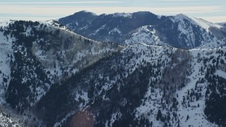 5.5K aerial stock footage of a Oquirrh Mountains ridge with snowdrifts in winter, Utah Aerial Stock Footage | AX125_171E