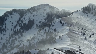 5.5K aerial stock footage of Oquirrh Mountains with snowdrifts in wintertime, Utah Aerial Stock Footage | AX125_185E