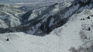 5.5K aerial stock footage of snowdrifts on peak and ridge in the Oquirrh Mountains, Utah Aerial Stock Footage | AX125_193E