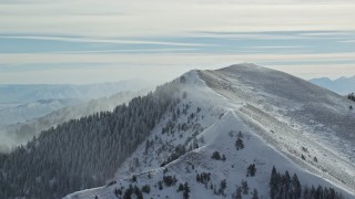 5.5K aerial stock footage approach snowy mountain peak with winter snowdrifts, Oquirrh Mountains, Utah Aerial Stock Footage | AX125_195E