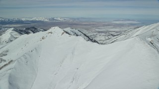 5.5K aerial stock footage of approaching snowy Oquirrh Mountains in wintertime, Utah Aerial Stock Footage | AX125_213