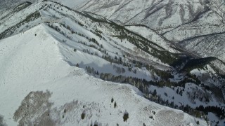 5.5K aerial stock footage approach snowy Oquirrh Mountains and tilt to a ridge, Utah Aerial Stock Footage | AX125_219E