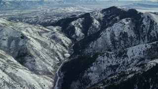 5.5K aerial stock footage of a mountain road through a canyon with winter snow, Oquirrh Mountains, Utah Aerial Stock Footage | AX125_222E