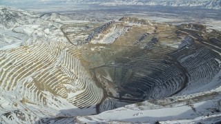 5.5K aerial stock footage of the Bingham Canyon Mine in winter with light snow in Utah Aerial Stock Footage | AX125_229E