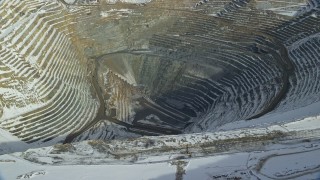 5.5K aerial stock footage of the bottom of the Bingham Canyon Copper Mine with winter snow, Utah Aerial Stock Footage | AX125_231