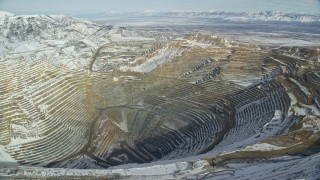 5.5K aerial stock footage of orbiting Bingham Canyon Mine with light winter snow in Utah Aerial Stock Footage | AX125_232