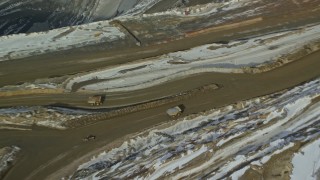 5.5K aerial stock footage orbit above gravel hauler at Bingham Canyon Mine in winter, Utah Aerial Stock Footage | AX125_236