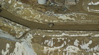 5.5K aerial stock footage of gravel haulers in the Bingham Canyon Copper Mine in winter, Utah Aerial Stock Footage | AX125_237E