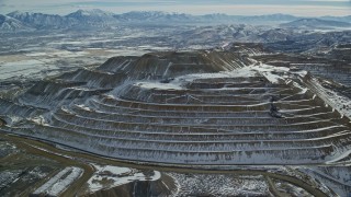 5.5K aerial stock footage of orbiting the side of the Bingham Canyon Copper Mine in winter, Utah Aerial Stock Footage | AX125_267E