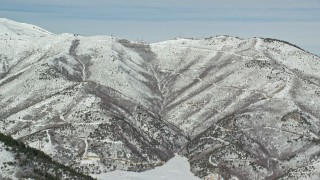 5.5K aerial stock footage of snow-covered mountain ridge in winter, Oquirrh Mountains, Utah Aerial Stock Footage | AX125_273