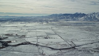 5.5K aerial stock footage of the town of Magna and snowy Oquirrh Mountains in winter, Utah Aerial Stock Footage | AX125_319