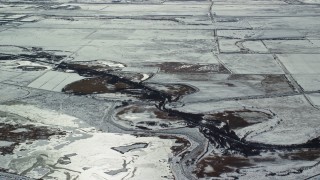 5.5K aerial stock footage of small canal through frozen countryside near Salt Lake City in winter, Utah Aerial Stock Footage | AX125_320E