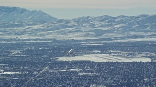 5.5K aerial stock footage track airliner soaring over Salt Lake City in winter, Utah Aerial Stock Footage | AX125_328E