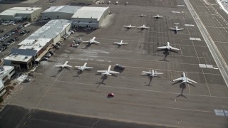 5.5K aerial stock footage fly over hangars and private planes at Salt Lake City Airport in winter, Utah Aerial Stock Footage | AX126_002