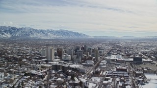 5.5K aerial stock footage orbit of Downtown Salt Lake City buildings with light winter snow, Utah Aerial Stock Footage | AX126_013E