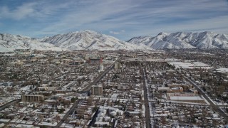 5.5K aerial stock footage orbit suburban neighborhoods by snowy mountains in winter, Salt Lake City, Utah Aerial Stock Footage | AX126_045