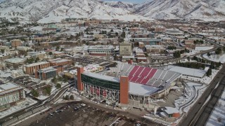 5.5K aerial stock footage fly over Rice-Eccles Stadium and University of Utah buildings with winter snow, Salt Lake City Aerial Stock Footage | AX126_048E