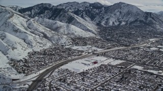 5.5K aerial stock footage of suburban neighborhoods around Interstate 215 in snowy Salt Lake City, Utah Aerial Stock Footage | AX126_066