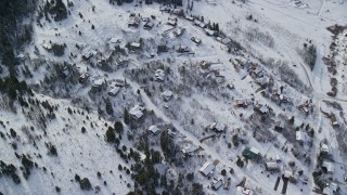 5.5K aerial stock footage of orbiting above upscale homes and evergreens with winter snow, Wasatch Range, Utah Aerial Stock Footage | AX126_089E