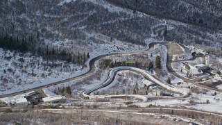 AX126_101 - 5.5K aerial stock footage orbit luge and bobsledding track with winter snow at Utah Olympic Park in Park City