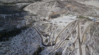 5.5K stock footage video aerial orbit tracks for luge and bobsledding events at Utah Olympic Park with winter snow, Park City Aerial Stock Footage | AX126_103E