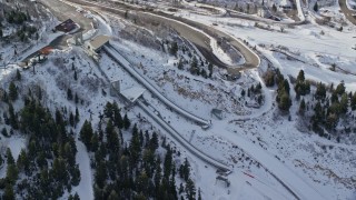 5.5K aerial stock footage of a pair of ski jumps with winter snow at Utah Olympic Park in Park City, Utah Aerial Stock Footage | AX126_108E