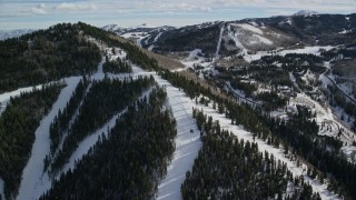 5.5K aerial stock footage flyby Canyons Resort ski runs on Iron Mountain toward mountainside mansions. Park City, Utah Aerial Stock Footage | AX126_118