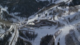 AX126_130E - 5.5K aerial stock footage orbit Montage Deer Valley Hotel near ski runs in Park City, Utah