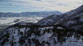 5.5K aerial stock footage pan and fly over snowy Wasatch Range mountain ridge in winter, Utah Aerial Stock Footage | AX126_188E