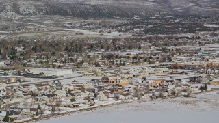 5.5K aerial stock footage orbit tract homes by snowy field on outskirts of Heber City in winter, Utah Aerial Stock Footage | AX126_216