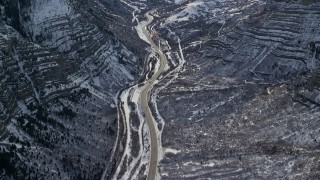 5.5K aerial stock footage of bird's eye of Provo Canyon Road through the snowy Wasatch Range in winter, Utah Aerial Stock Footage | AX126_248E