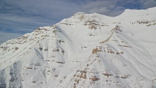 5.5K aerial stock footage of Mount Timpanogos slopes covered in winter snow in Utah Aerial Stock Footage | AX126_260E