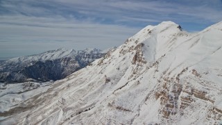 5.5K aerial stock footage approach the north end of snowy Mount Timpanogos in winter, Utah Aerial Stock Footage | AX126_266