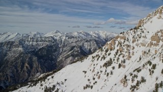 5.5K stock footage video pan across northern slopes of Mount Timpanogos to distant mountains in winter, Utah Aerial Stock Footage | AX126_269E