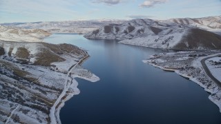 5.5K aerial stock footage fly over Deer Creek Reservoir toward Heber City on the distant snowy shore, Utah Aerial Stock Footage | AX126_307E