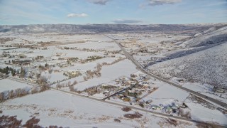 5.5K aerial stock footage approach Heber City from reservoir, and fly over the town with winter snow, Utah Aerial Stock Footage | AX126_317E